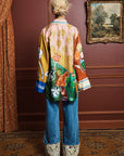 Relaxed fit silk shirt: ALÉMAIS MLAK graphic print top showing full-length sleeves with deep cuffs and side splits.