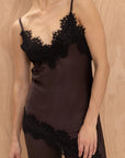 V-neck satin cami: Close-up of the delicate black contrast lace trim on the chocolate Charli Blake top.