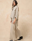 Estilo Emporio Linen Pant Novo Flare - Brasile Natural worn by model in natural setting LUXAMORE