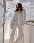 Estilo Emporio Linen Pant Novo Flare - Brasile Panna White worn by model in natural setting LUXAMORE