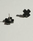 Mingled Black Cross Stud Earrings - Small Cross Earrings, Minimalist worn by model in natural setting LUXAMORE