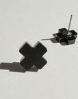 Mingled Black Cross Stud Earrings - Small Cross Earrings, Minimalist worn by model in natural setting LUXAMORE