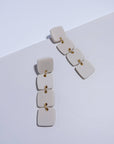 Mingled Dangle Earrings - Ivory Beige Four Squared Long Drop worn by model in natural setting LUXAMORE