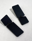 Mingled Dangle Earrings in Black Bauhaus Asymmetrical worn by model in natural setting LUXAMORE