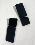 Mingled Dangle Earrings in Black Bauhaus Asymmetrical worn by model in natural setting LUXAMORE