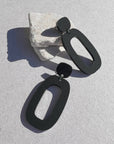 Woman Wearing Mingled Riley Matte Black Statement Earrings - Earings LUXAMORE