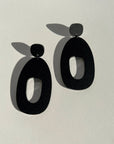 Woman Wearing Mingled Soko Large Matte Black Statement Earrings - Earings LUXAMORE