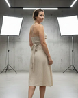 Linen Dress Cross Tie Made in Italy beige worn by model in natural setting LUXAMORE