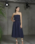 Italian Linen Dress Strapless Navy worn by model in natural setting LUXAMORE