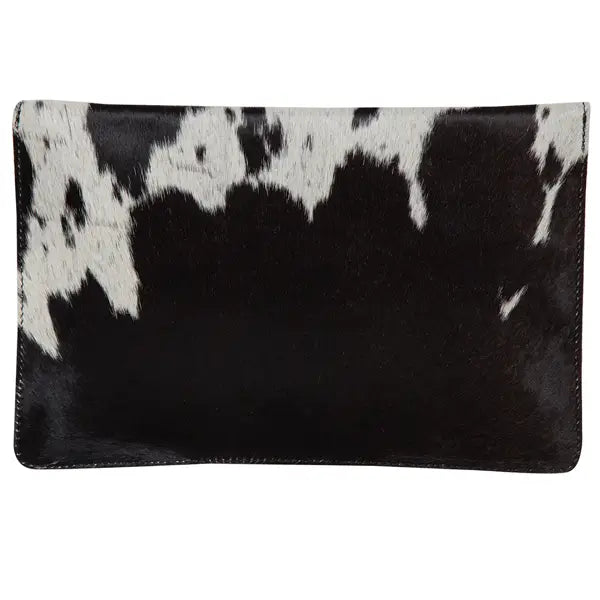 woman clutching cowhide clutch