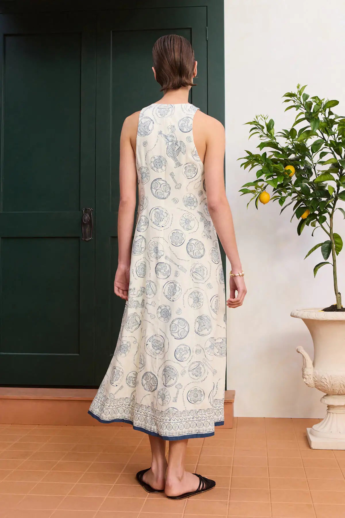 Fitted linen midi dress: ALÉMAIS Lucky Lace Up Midi Dress side view showing the structured, sleeveless holiday silhouette.. LUXAMORE