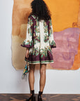 .Feminine resort mini dress: ALÉMAIS Ruthie dress showing the matching self-tie rouleau belt and fluid ruffle hem. LUXAMORE