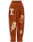 Woman Wearing Alemais Soleil d’Amour Silk Tapered Pants - Pants LUXAMORE
