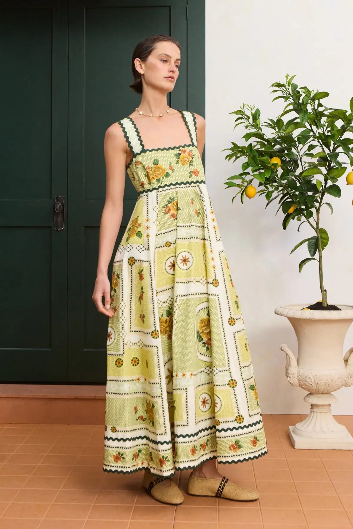 Vibrant citrus midi dress: ALÉMAIS Dixie Summer Dress close up showing the delicate scalloped embroidery and fitted bust.. LUXAMORE