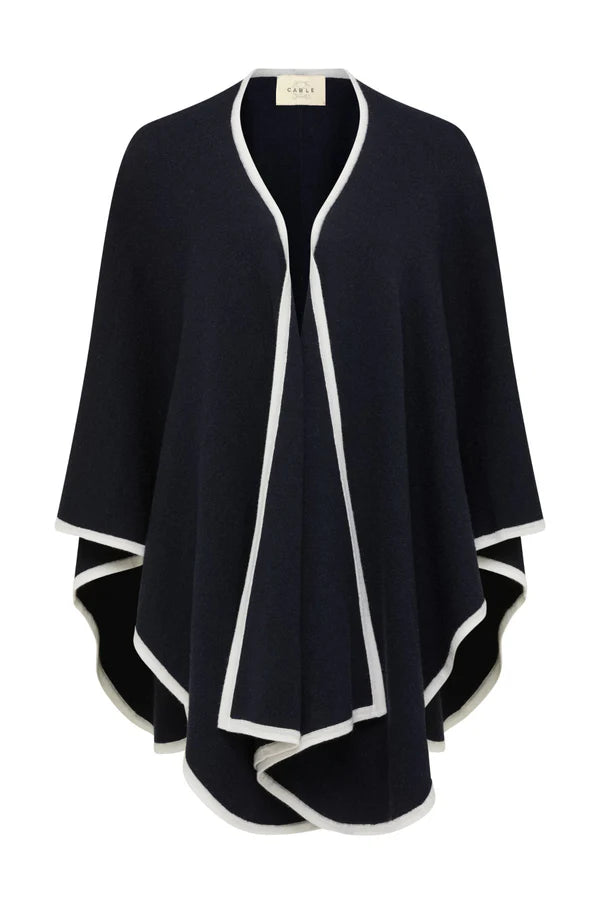Cable Melbourne Woman wearing the Glenelg Merino Cape in Midnight Navy, a medium-weight wool cape with contrast trim, styled for cool-weather layering.

