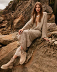 Estilo Emporio Linen Pant Novo Flare - Brasile Natural worn by model in natural setting LUXAMORE 