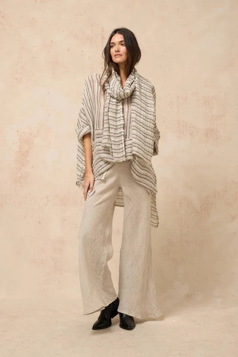 Estilo Emporio Linen Pant Novo Flare - Brasile Natural worn by model in natural setting LUXAMORE 