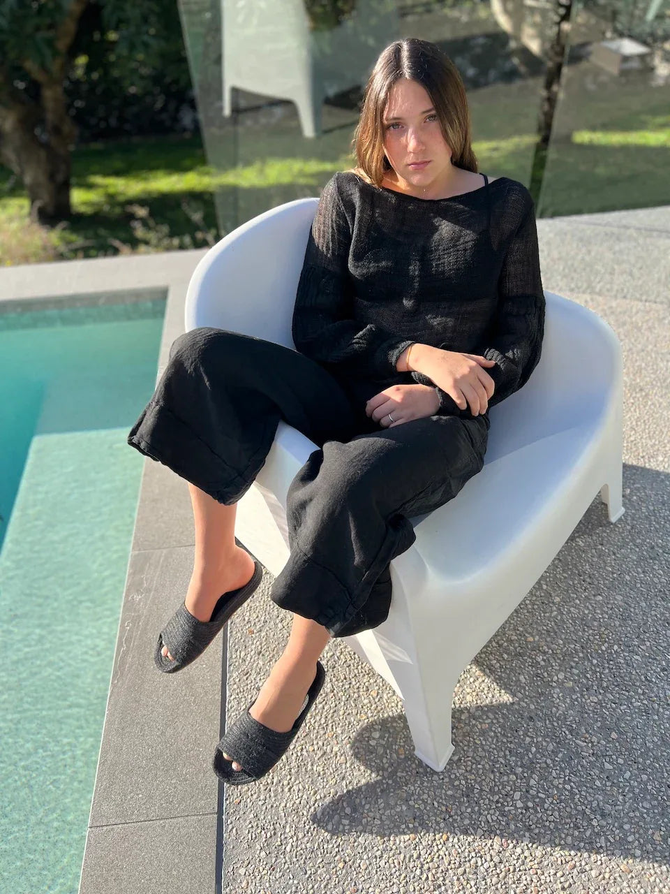 Estilo Emporio Stevie Top - Black worn by model in natural setting LUXAMORE 