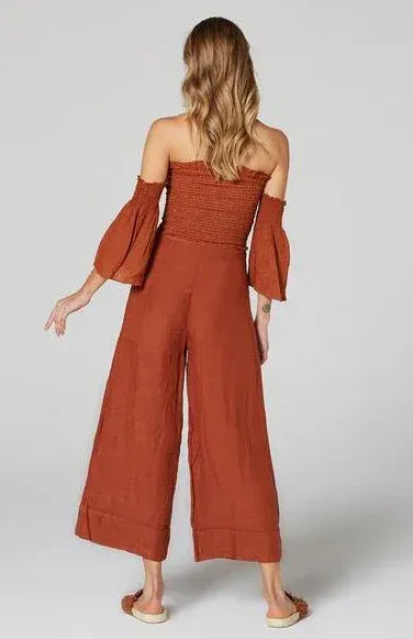 Estilo Emporio Linen Pant Tropez - Rust worn by model in natural setting LUXAMORE 