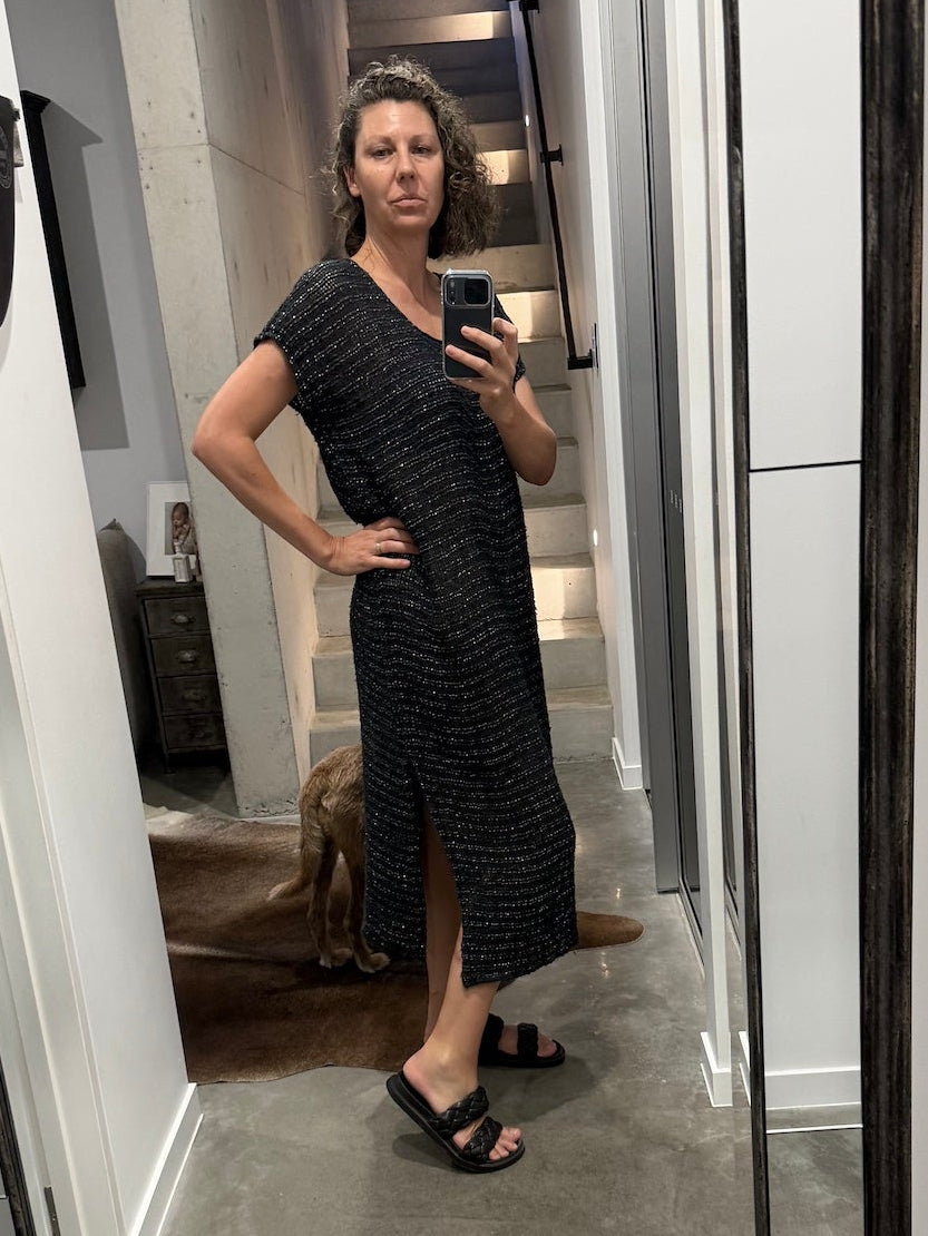 Woman taking a mirror selfie wearing a la bottega di brunella linen dress made in italy in a room with a large mirror.