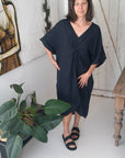 Woman Wearing Linen Dress V-neck Knot Front Midi Made in Italy Black - Dress LUXAMORE