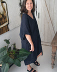 Woman Wearing Linen Dress V-neck Knot Front Midi Made in Italy Black - Dress LUXAMORE