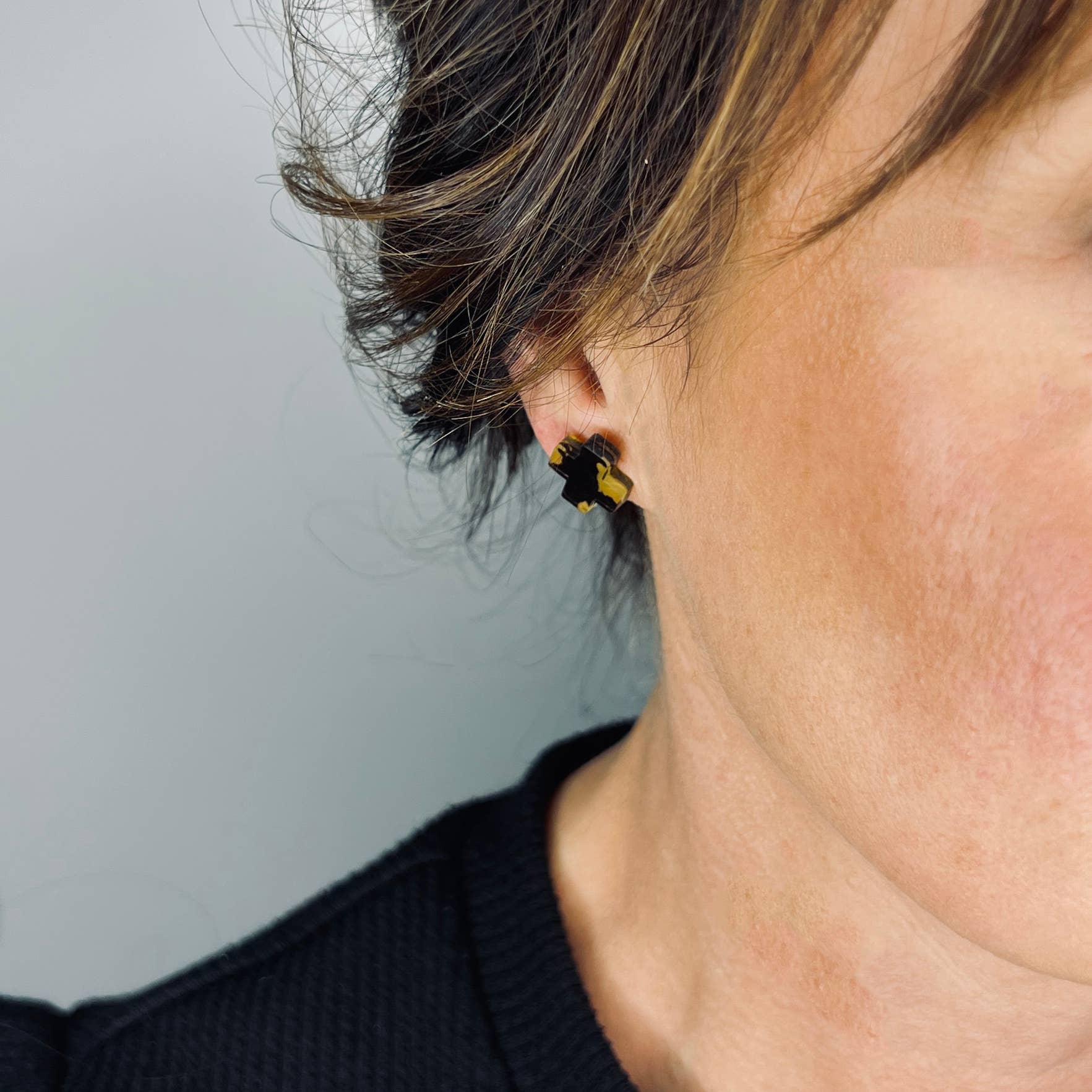 Woman Wearing Mingled Black Cross Stud Earrings - Small Cross Earrings, Minimalist - Earings LUXAMORE