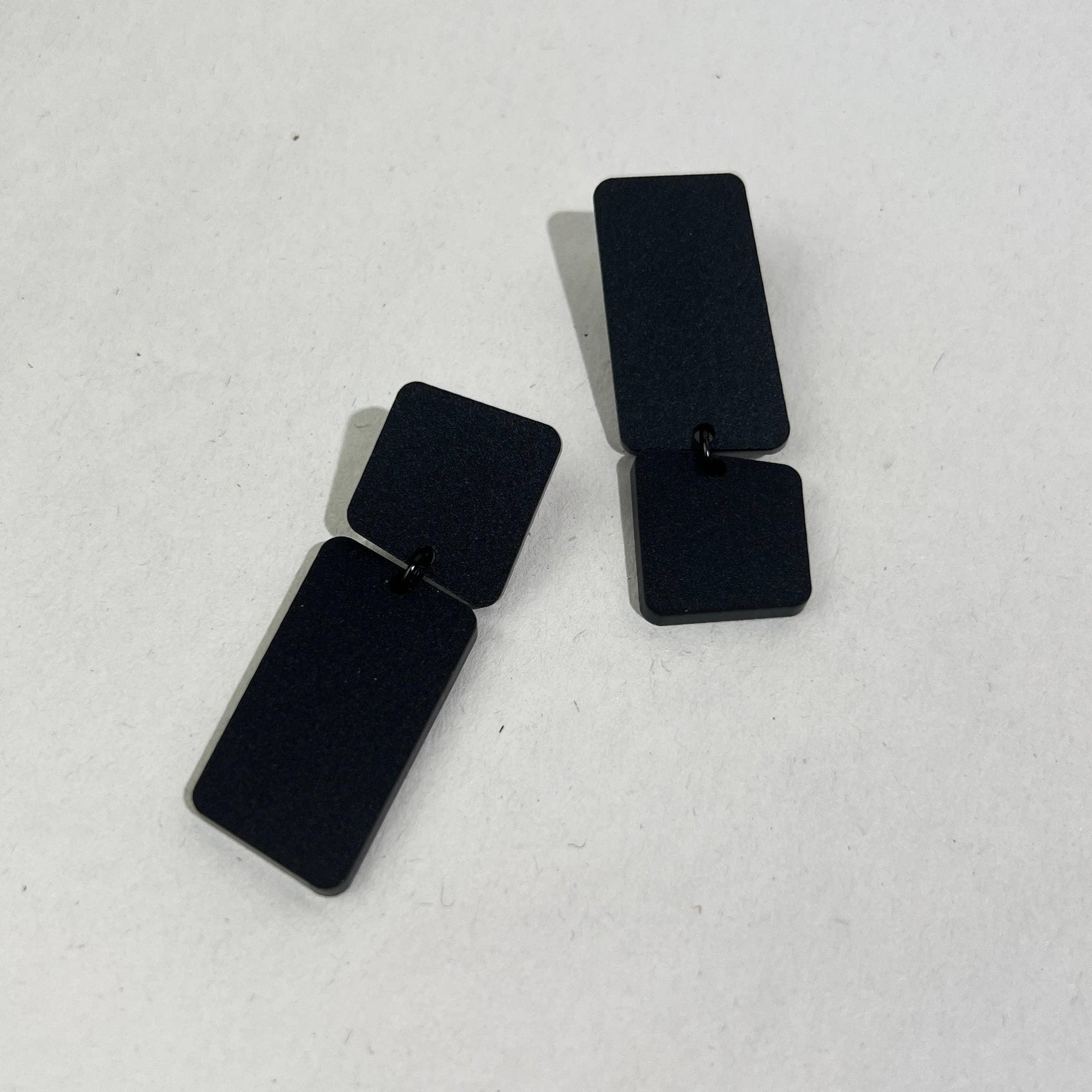 Mingled Dangle Earrings in Black Bauhaus Asymmetrical worn by model in natural setting LUXAMORE 