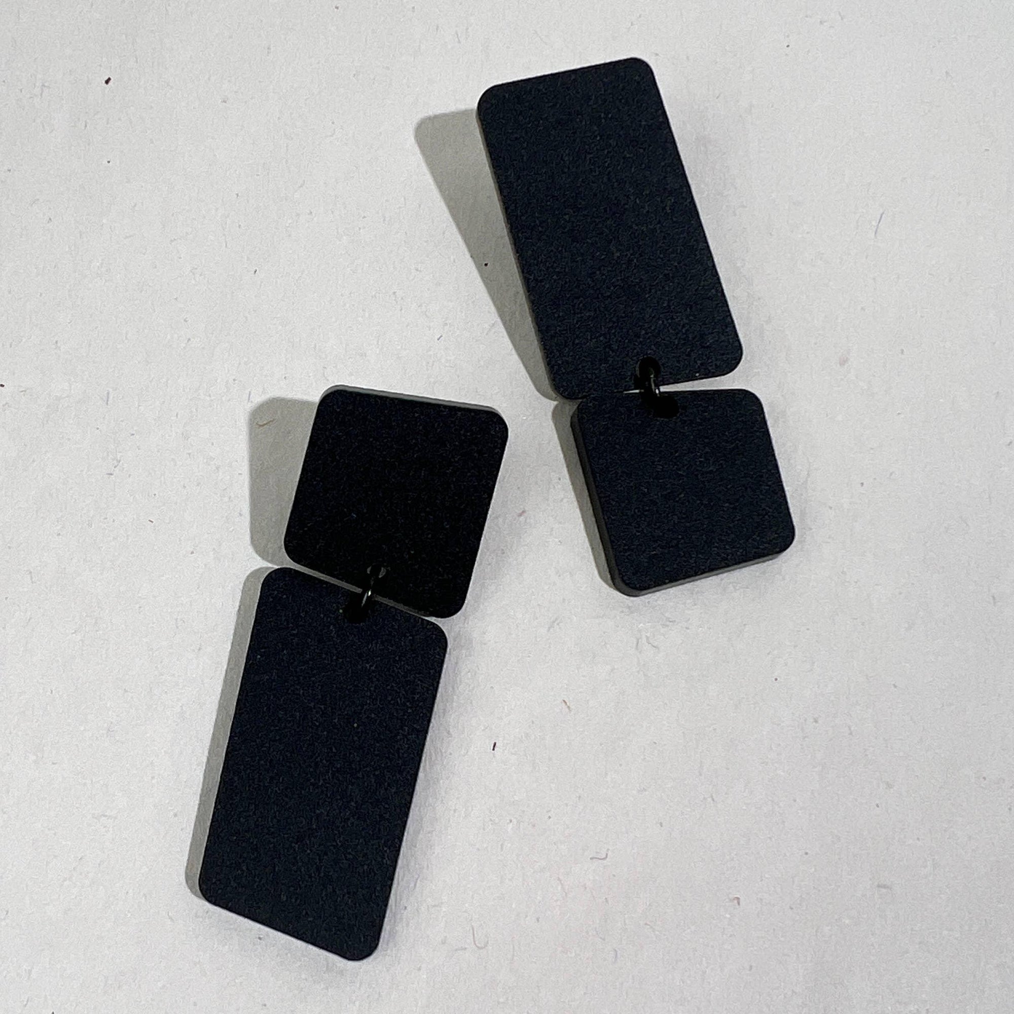 Mingled Dangle Earrings in Black Bauhaus Asymmetrical worn by model in natural setting LUXAMORE 