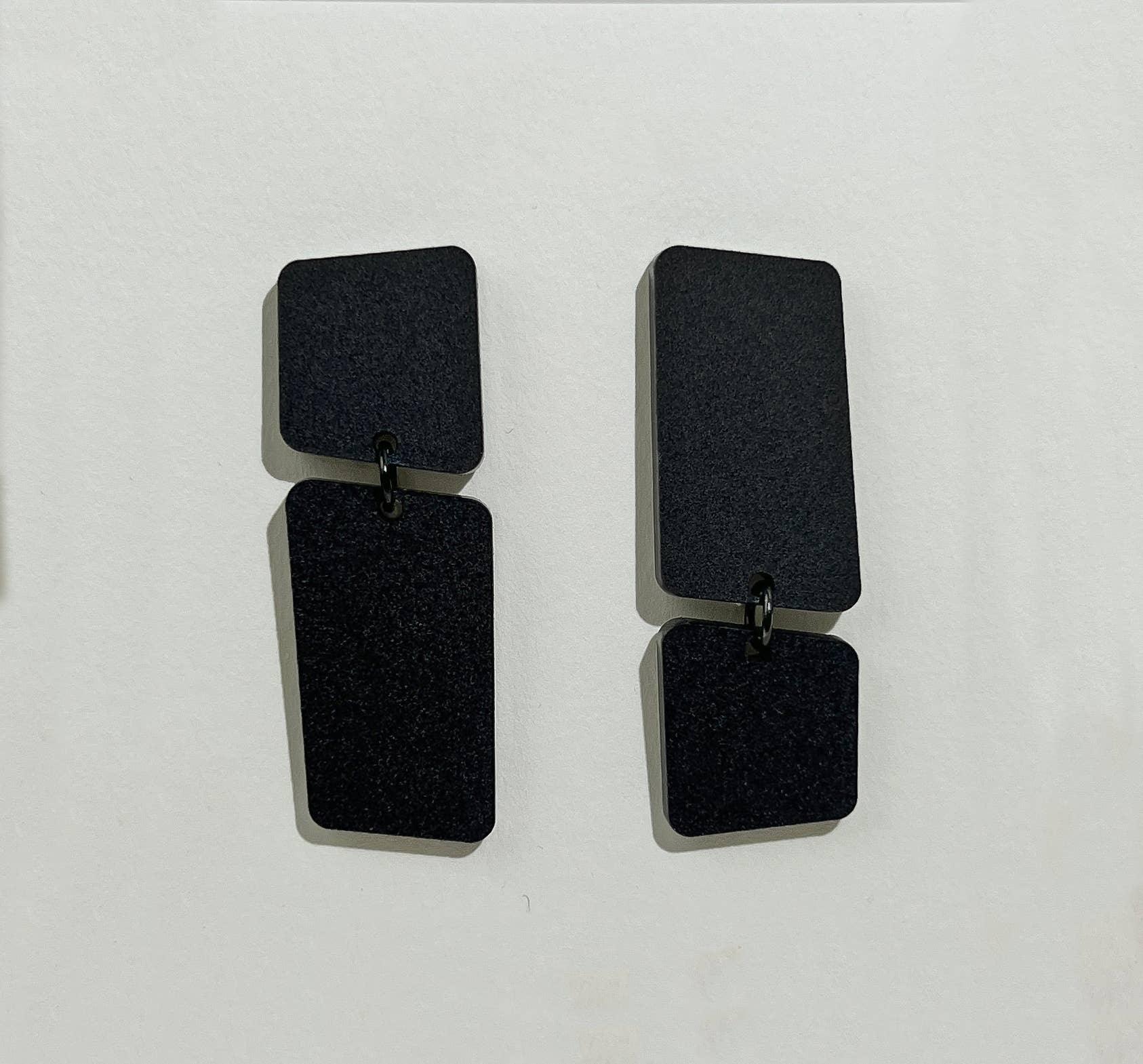 Mingled Dangle Earrings in Black Bauhaus Asymmetrical worn by model in natural setting LUXAMORE 