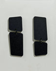 Mingled Dangle Earrings in Black Bauhaus Asymmetrical worn by model in natural setting LUXAMORE 