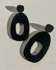 Woman Wearing Mingled Soko Large Matte Black Statement Earrings - Earings LUXAMORE