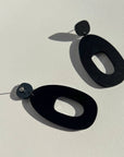 Woman Wearing Mingled Soko Large Matte Black Statement Earrings - Earings LUXAMORE