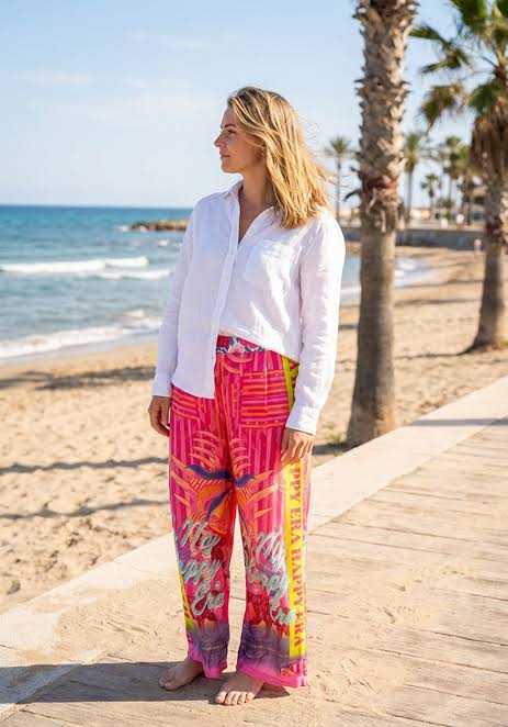 Wide-leg 7/8 trousers: Miss Goodlife Pants Sunset Dream in an all-over multicolor print with a wide waistband. LUXAMORE