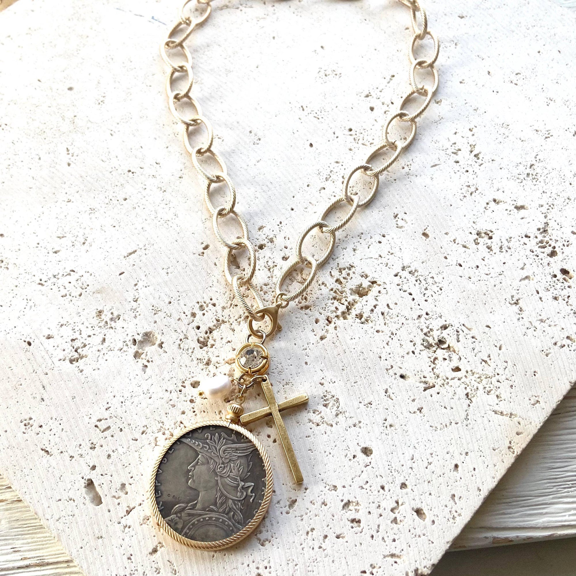 Pre Order Chunky coin necklace cross matte gold jewelry worn by model in natural setting LUXAMORE 