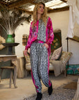 Pre Order Miss Goodlife Pink Animal Love Pants worn by model in natural setting LUXAMORE 