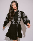 Verona Black & White Short Boho Embroidered Dress worn by model in natural setting LUXAMORE 