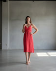 Italian Linen Dress Cross tie Coral Made in Italy worn by model in natural setting LUXAMORE 