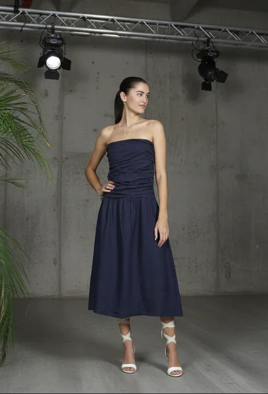 Italian Linen Dress Strapless Navy worn by model in natural setting LUXAMORE 